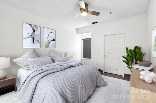 a bedroom with a potted plant with a bed and a potted plant