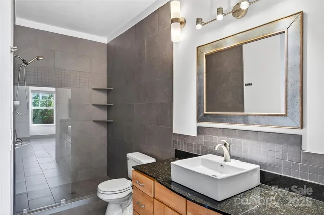 a bathroom with a sink toilet and mirror