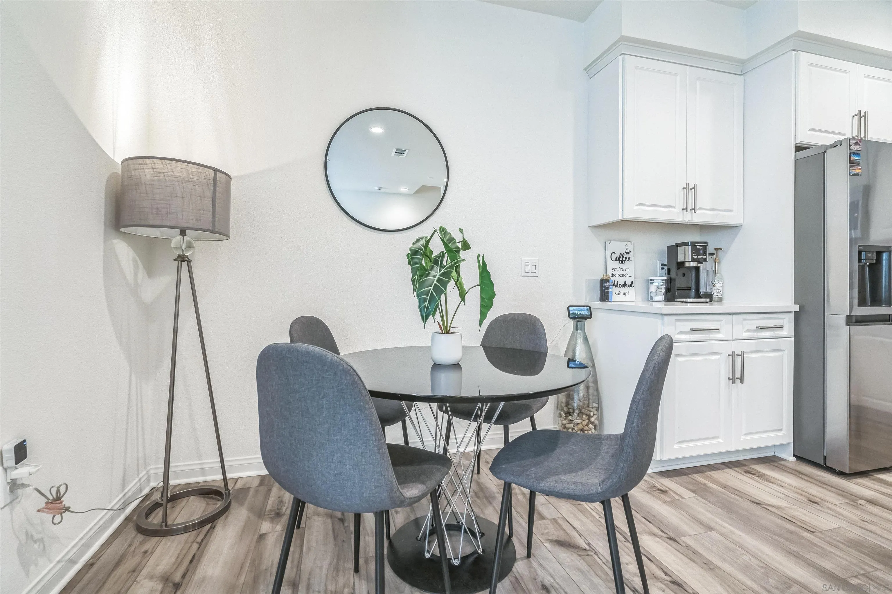 2018 Barite Street Spring Valley, CA 91977 - Photo 42 of 47 a view of a dining room with furniture a potted plant and wooden floor