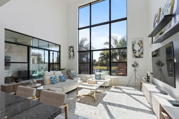 a living room with fireplace furniture and a large window