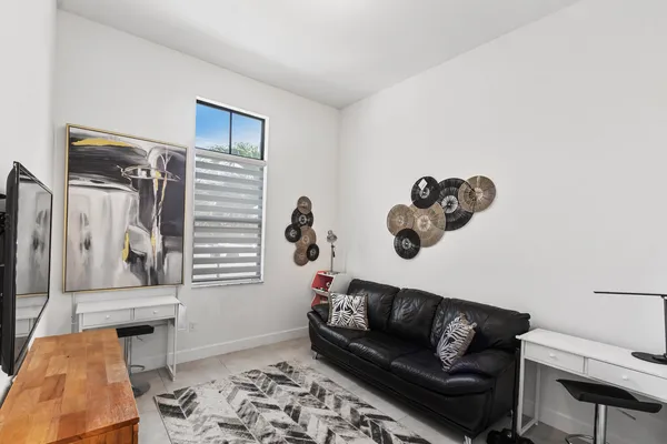 a view of a livingroom with furniture and closet area
