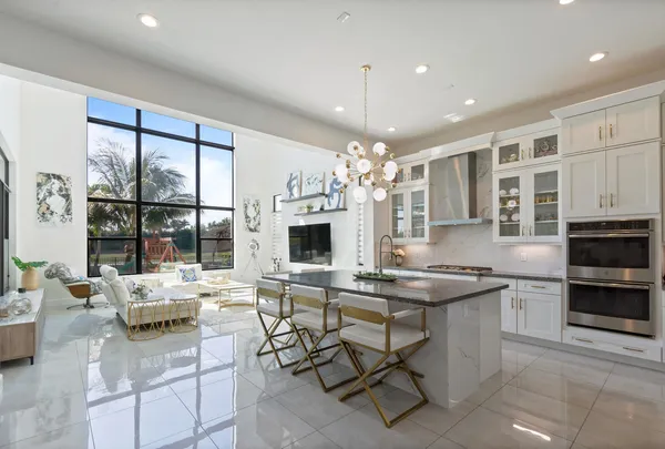 a kitchen with stainless steel appliances kitchen island granite countertop a sink and cabinets