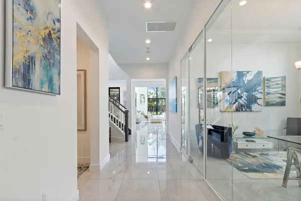 a dining hall with stainless steel appliances granite countertop a sink and a large window