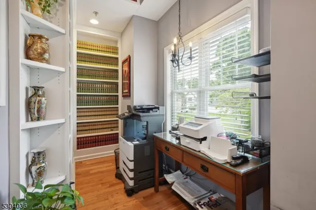 a view of a workspace with furniture and a window