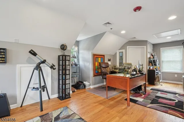a living room with furniture a dining table and wooden floor