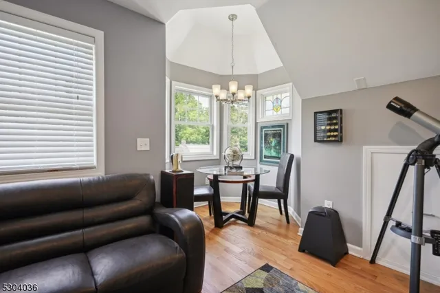 a living room with furniture and a chandelier