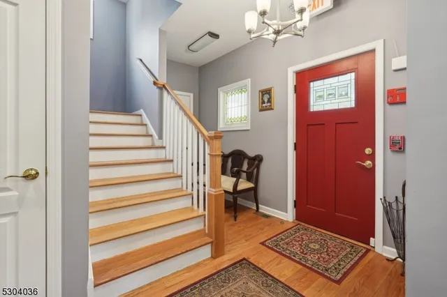 a view of entryway with furniture and wooden floor