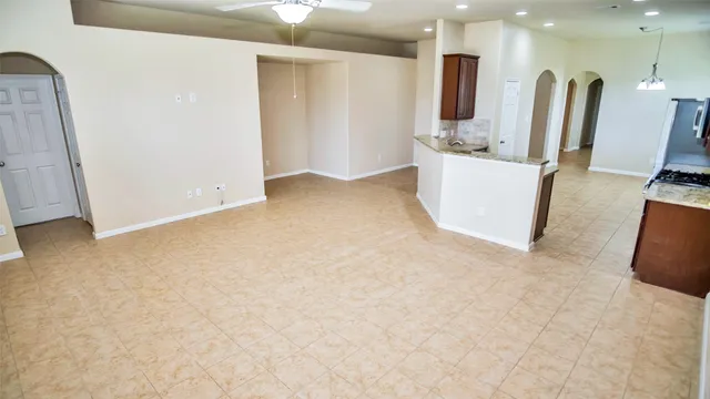 a view of a kitchen with kitchen island and a sink