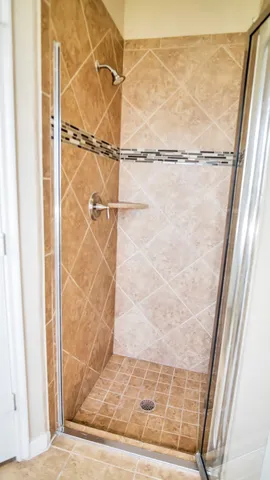 a bathroom with a glass shower door