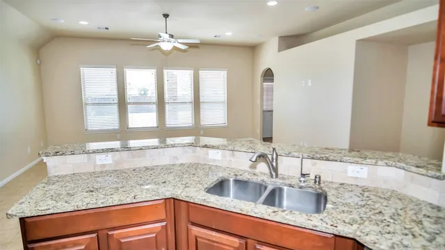 a kitchen with granite countertop a sink and a window