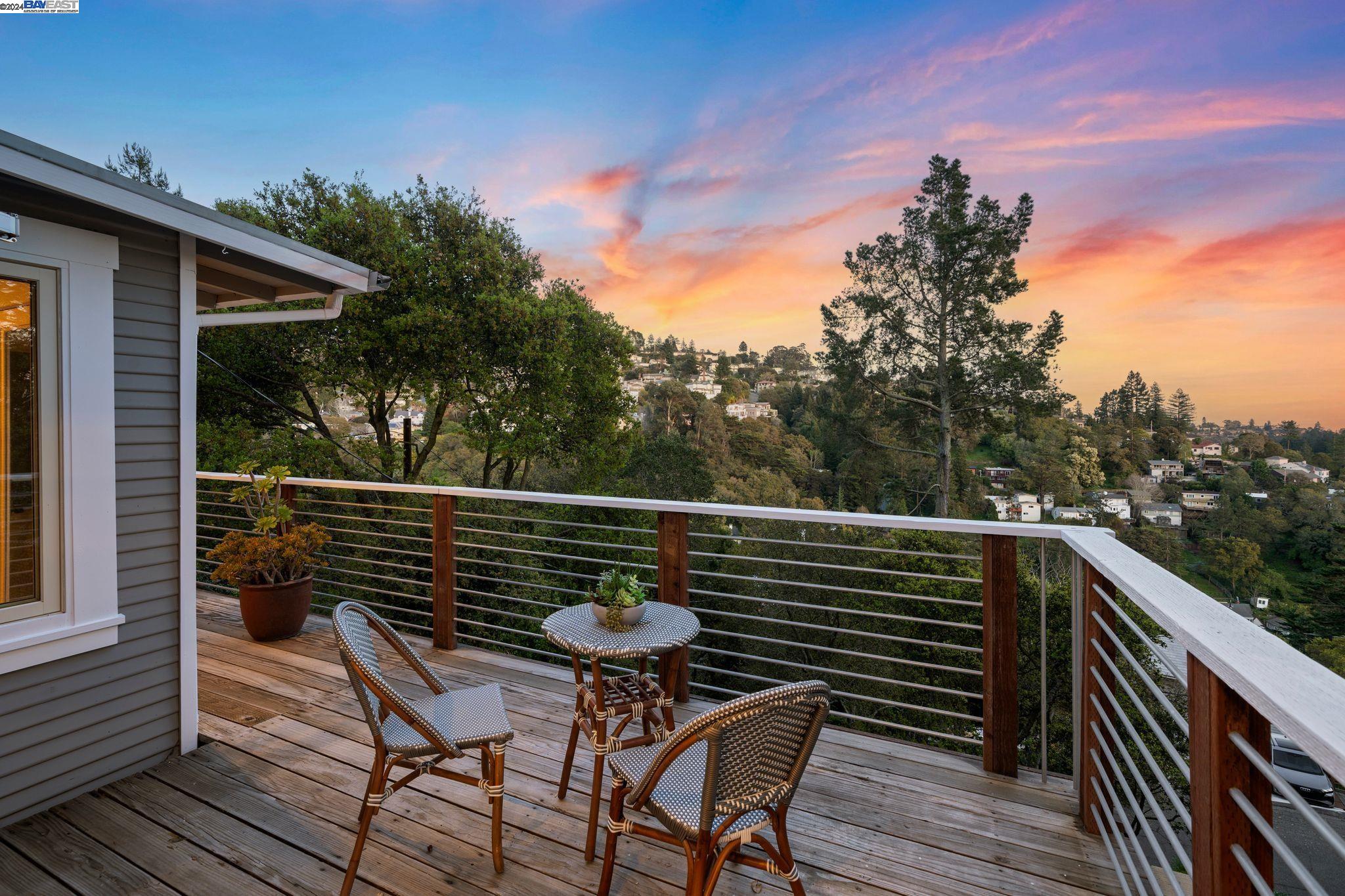 a balcony with wooden floor table and chairs
