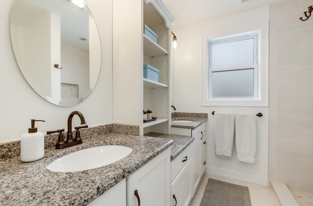 10 Maple Way Wakefield, MA 01880 - Photo 15 of 26 a bathroom with double sink and a mirror