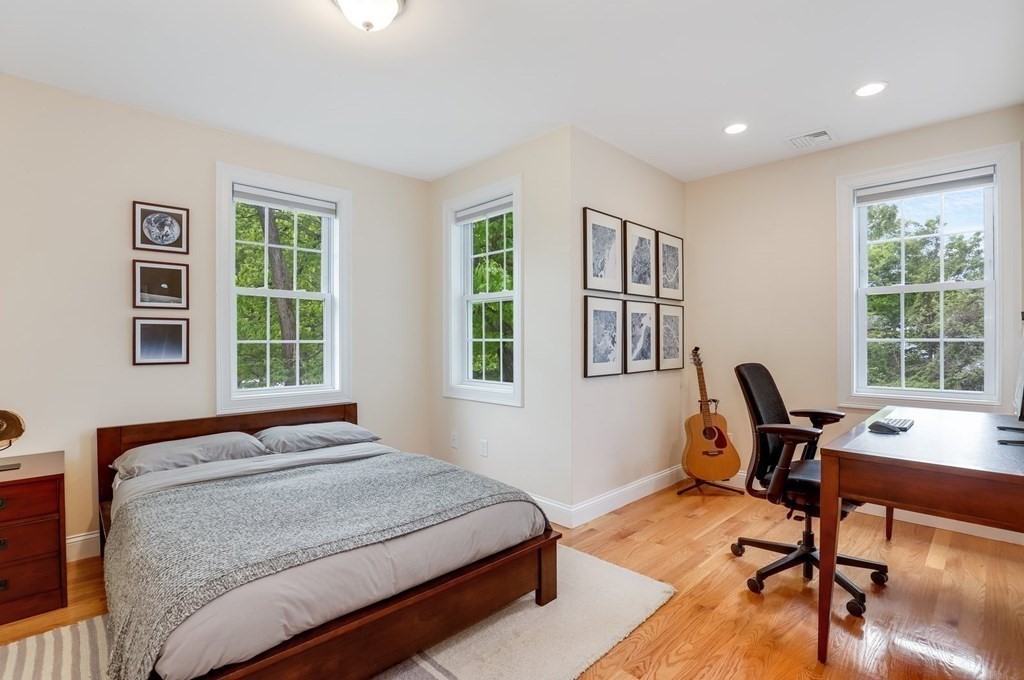 10 Maple Way Wakefield, MA 01880 - Photo 17 of 26 a bedroom with a bed a table and a window