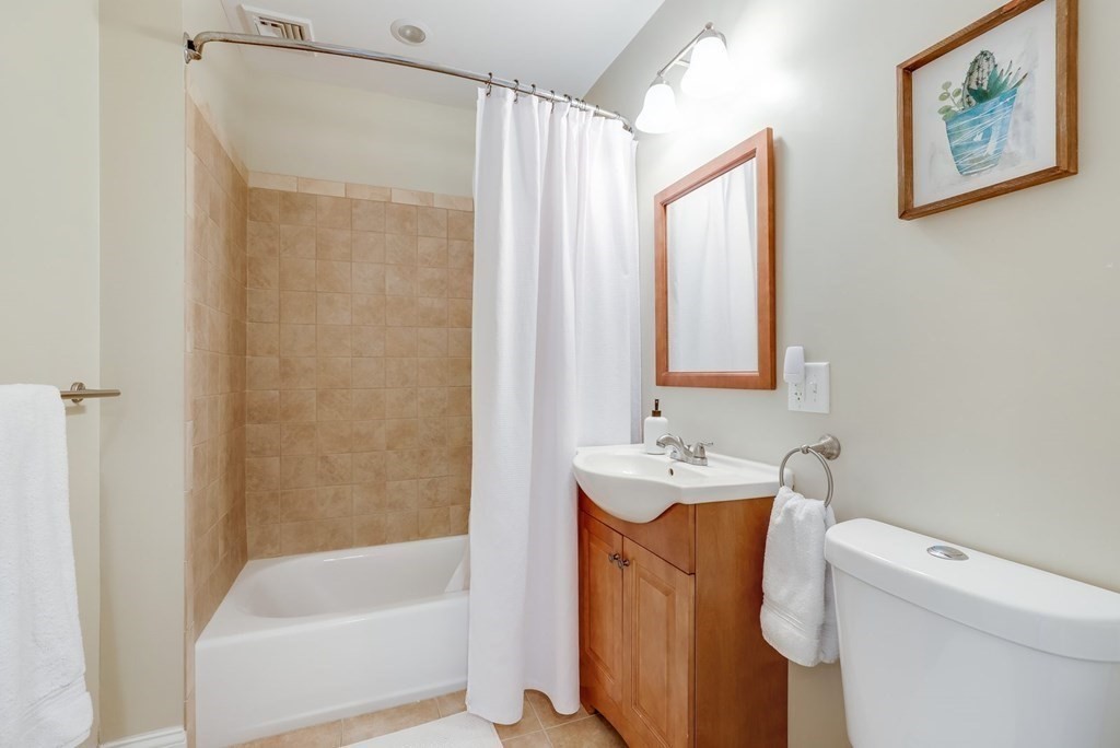 10 Maple Way Wakefield, MA 01880 - Photo 21 of 26 a bathroom with a sink toilet and shower