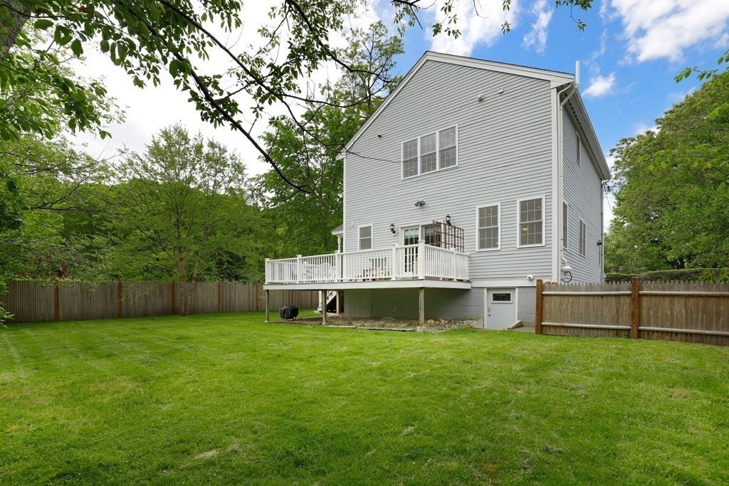 10 Maple Way Wakefield, MA 01880 - Photo 26 of 26 a view of a house with a large window and wooden fence