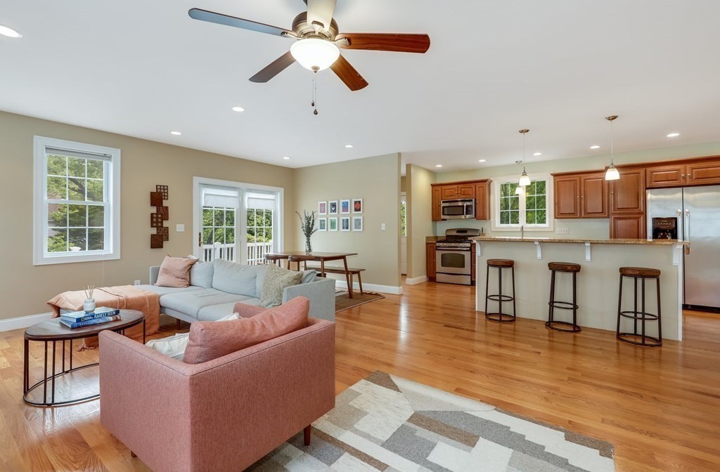 10 Maple Way Wakefield, MA 01880 - Photo 6 of 26 a living room with fireplace furniture and a wooden floor