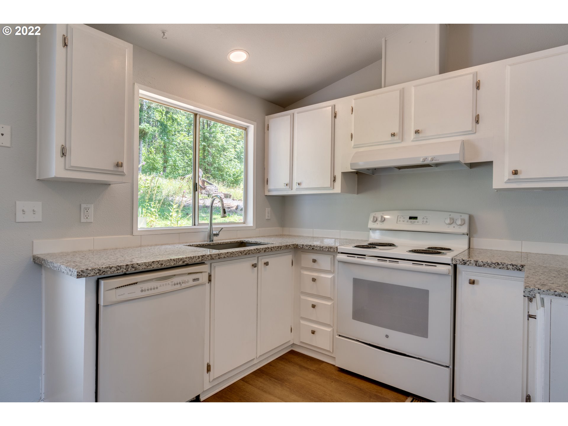 35355 Southeast Surface Road Estacada, OR 97023 - Photo 11 of 32 a kitchen with granite countertop white cabinets and white appliances