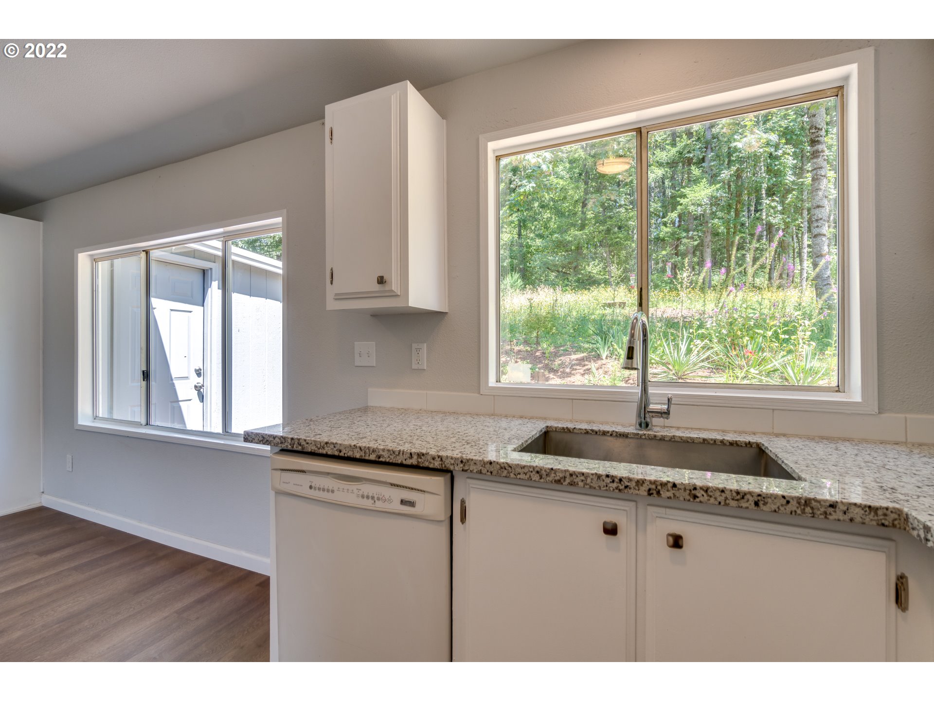 35355 Southeast Surface Road Estacada, OR 97023 - Photo 12 of 32 a kitchen with granite countertop white cabinets and a window