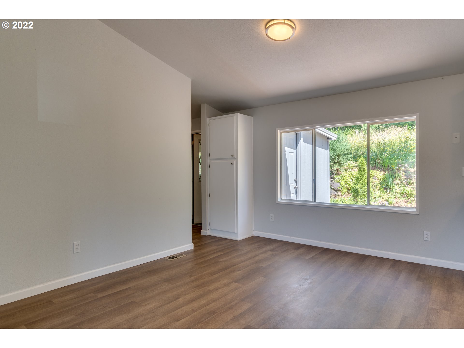 35355 Southeast Surface Road Estacada, OR 97023 - Photo 14 of 32 a view of an empty room with wooden floor and a window