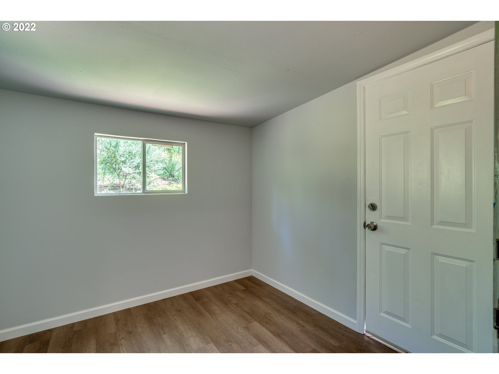 35355 Southeast Surface Road Estacada, OR 97023 - Photo 16 of 32 a view of an empty room with wooden floor and a window