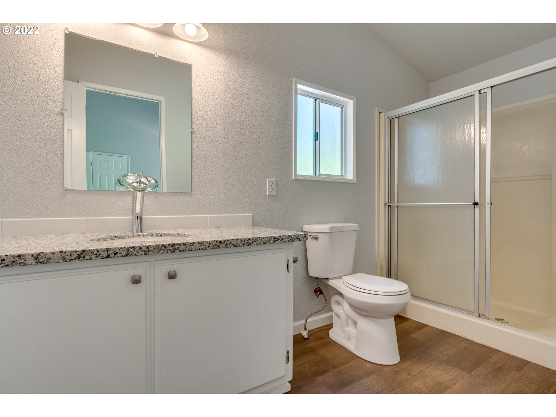 35355 Southeast Surface Road Estacada, OR 97023 - Photo 22 of 32 a bathroom with a granite countertop toilet a sink and a mirror