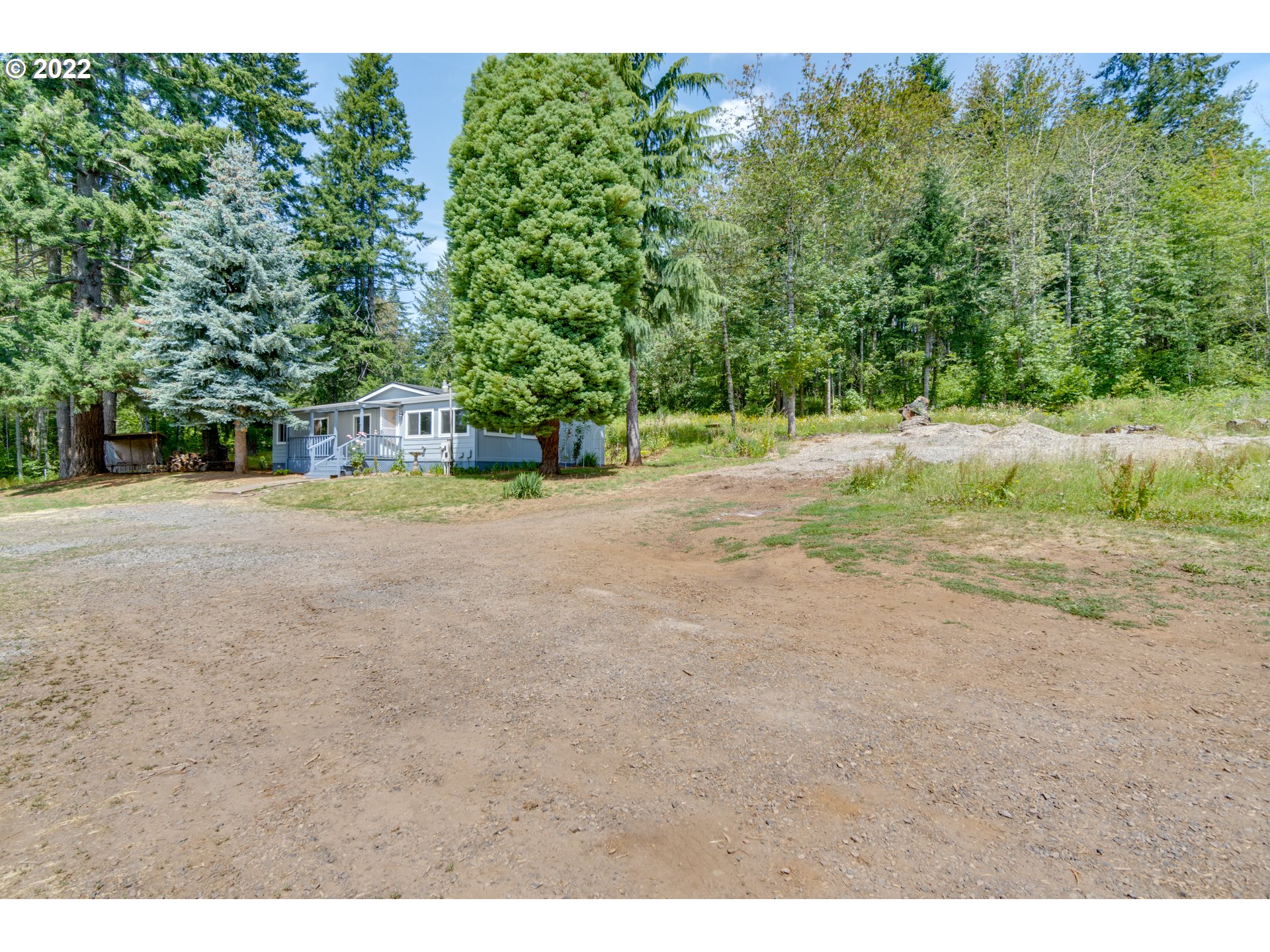 35355 Southeast Surface Road Estacada, OR 97023 - Photo 30 of 32 a view of dirt field with trees in the background