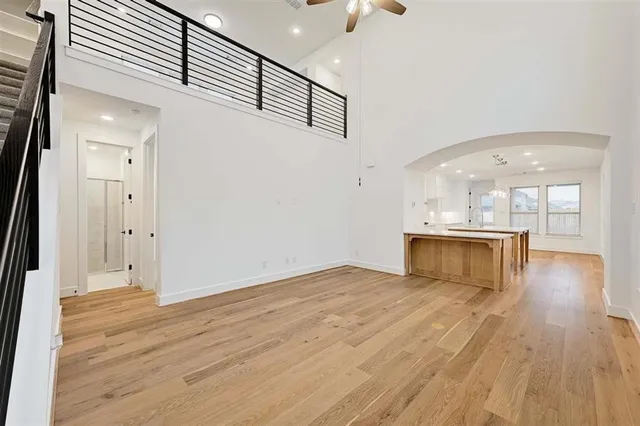 a view of a kitchen with wooden floor and a window