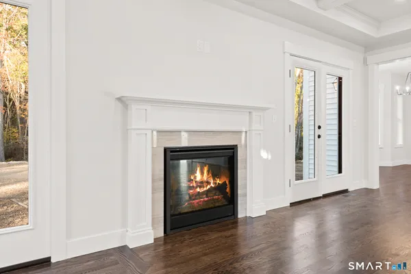 a room with a fireplace and wooden floor