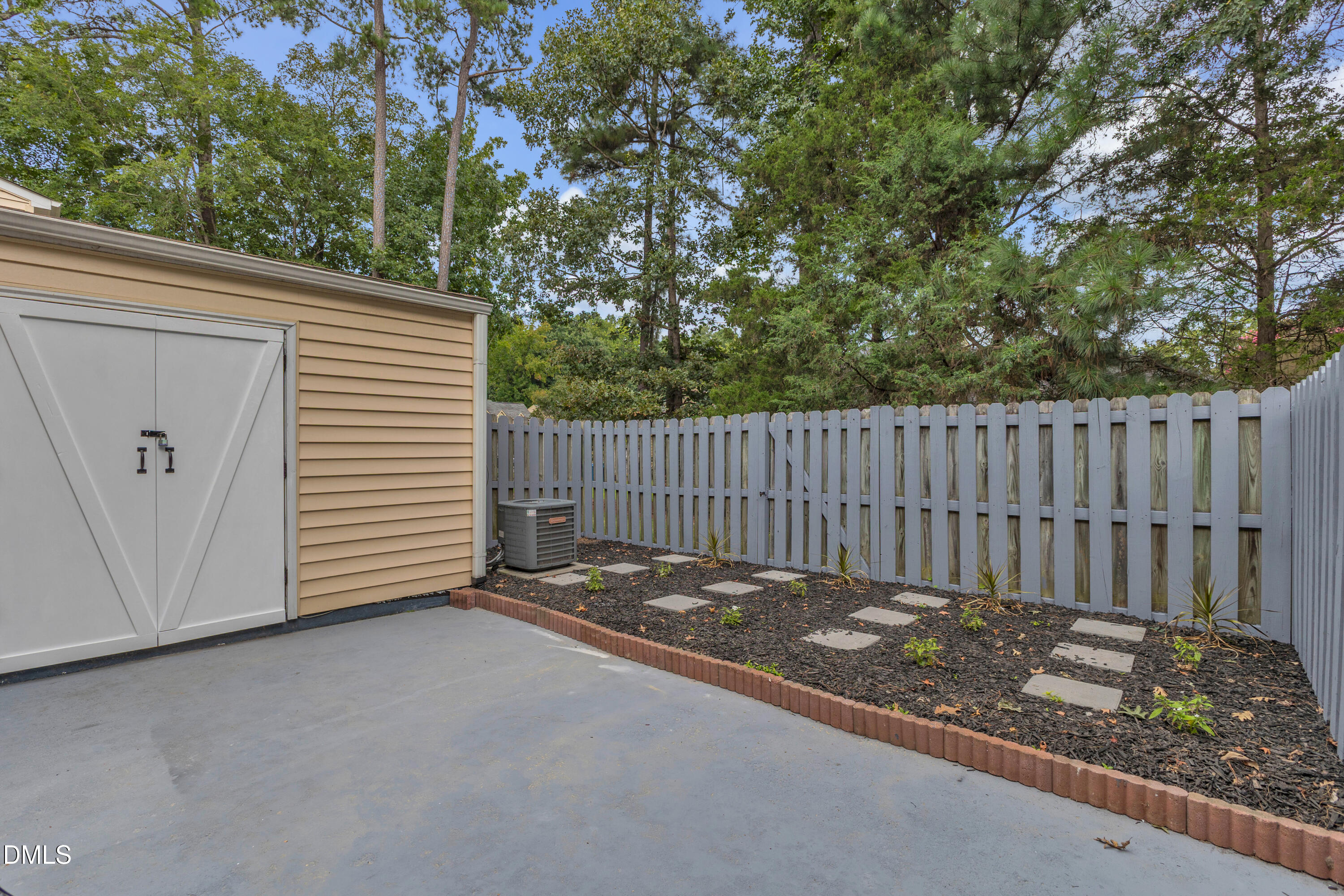 12 Patriot Circle Durham, NC 27704 - Photo 11 of 13 a view of a backyard with a small cabin and wooden fence