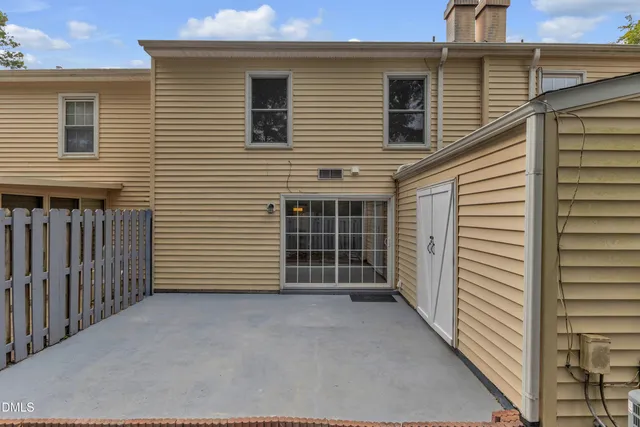 a view of a backyard with a small cabin and wooden fence