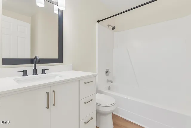 a bathroom with a double vanity sink toilet and shower