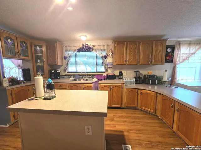 a kitchen with granite countertop a sink and white appliances