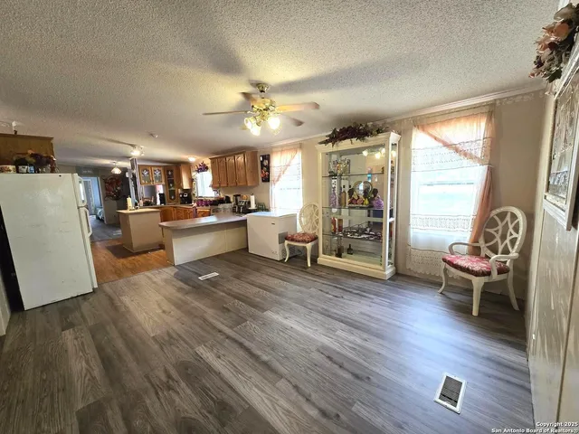 a living room with furniture and wooden floors