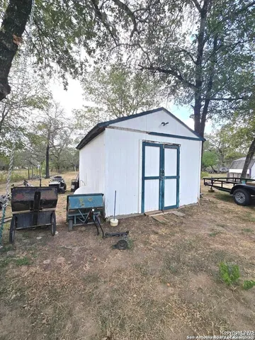 a view of a house with a backyard and sitting area