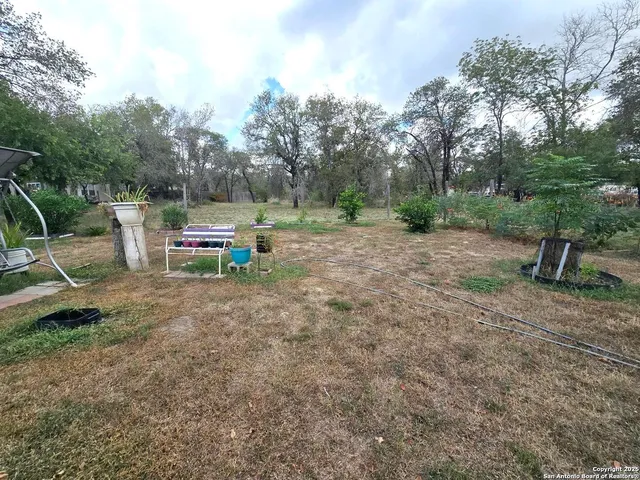 a view of outdoor space with playground and green space