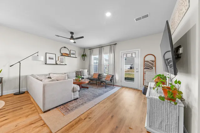 a living room with furniture and a large window