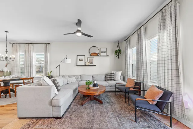 a living room with furniture and kitchen view