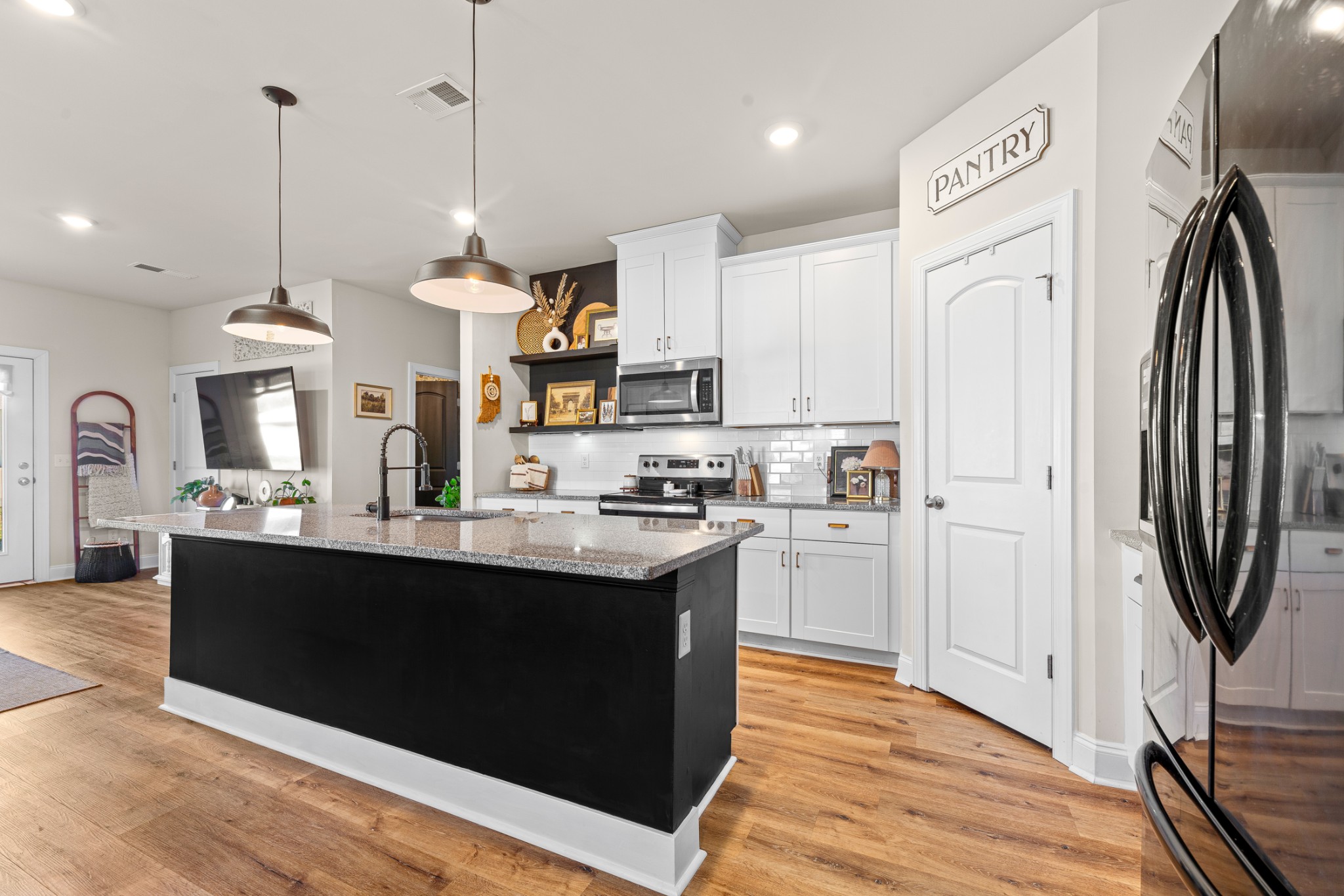 744 Prairie View Drive Columbia, TN 38401 - Photo 23 of 60 a kitchen with stainless steel appliances granite countertop a refrigerator a sink dishwasher a stove and white cabinets with wooden floor