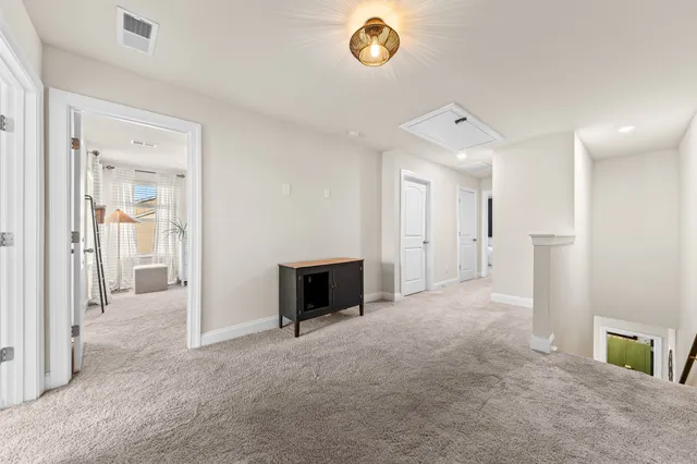 a spacious bedroom with a bed and a flat screen television