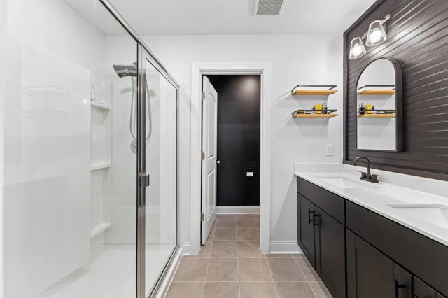 a bathroom with a double vanity sink mirror and toilet