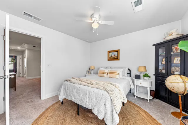 a view of a house with a yard and a large tree
