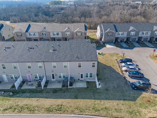 an aerial view of a house with a mountain