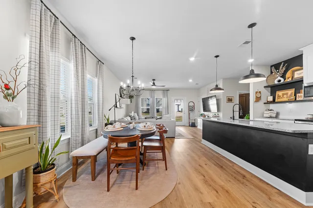 a dining room with furniture and wooden floor