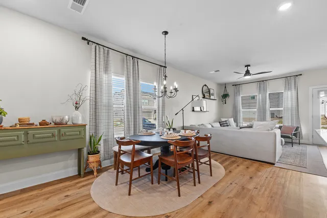 a view of a dining room with furniture window and wooden floor