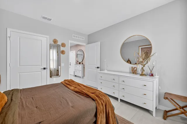 a bedroom with a bed and a dresser