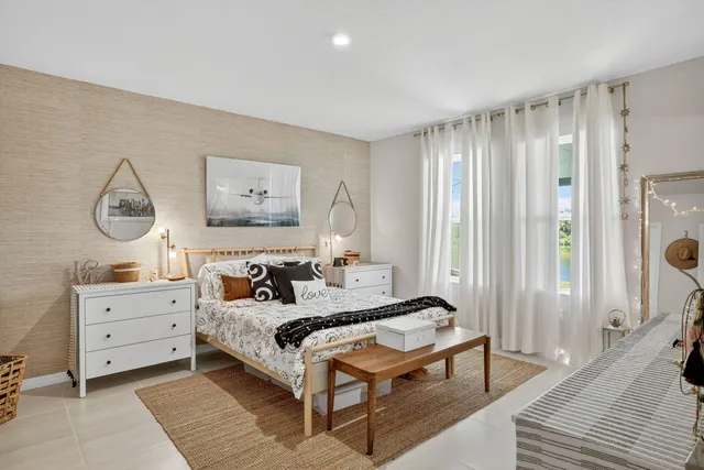 a spacious bedroom with a bed and a chandelier