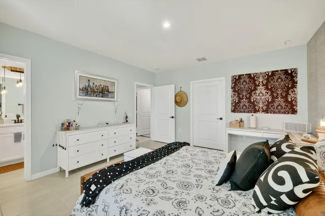 a bedroom with a bed and cabinets