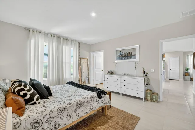 a bedroom with a bed and a dresser