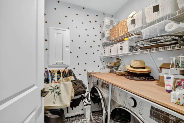 a utility room with sink dryer and washer
