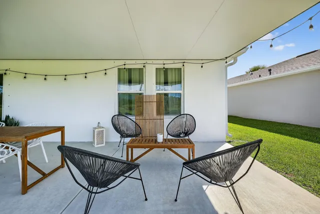 a view of a chairs and table in backyard